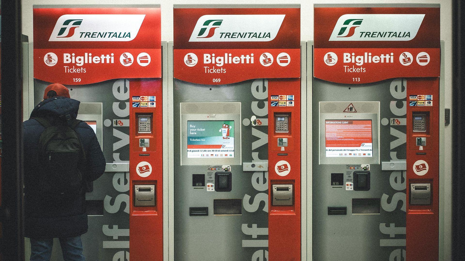 Ticket Machine Trenitalia Stations with a guy with a backpack and getting a train to Abruzzo.