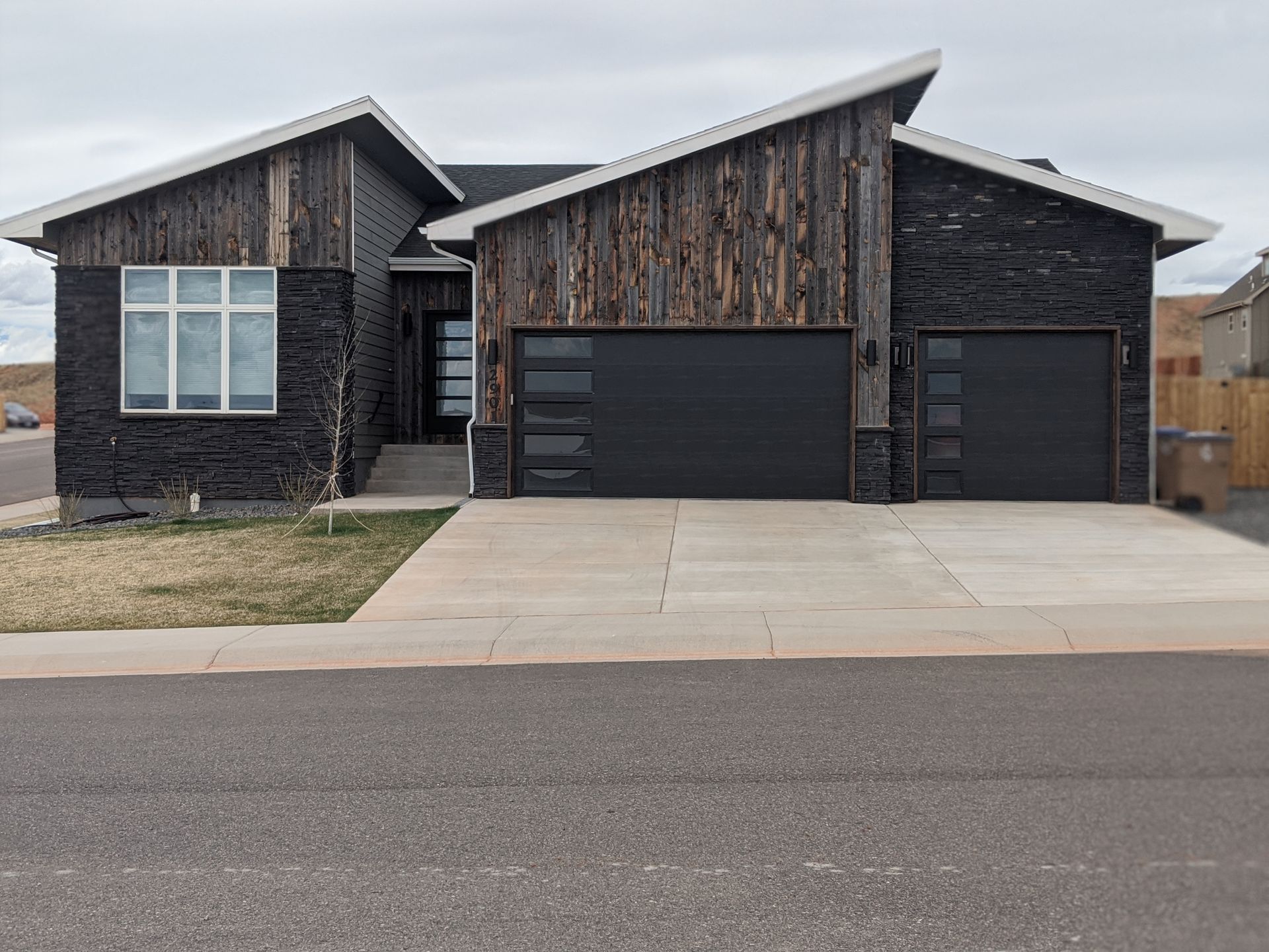 Black House with Black Garage Door — Laramie, WY — Southeastern Wyoming Garage Doors