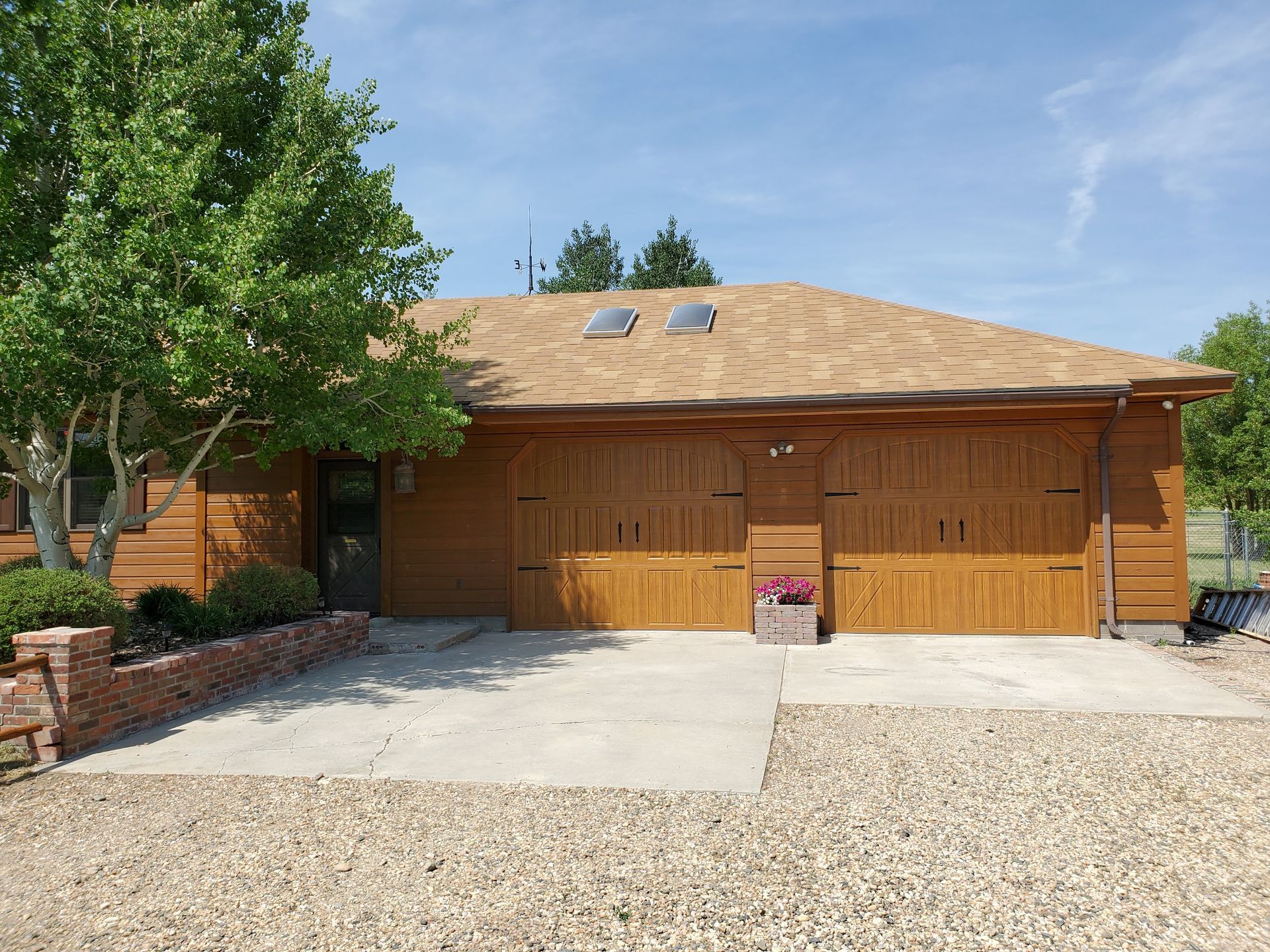 House with Wooden Garage Door — Laramie, WY — Southeastern Wyoming Garage Doors