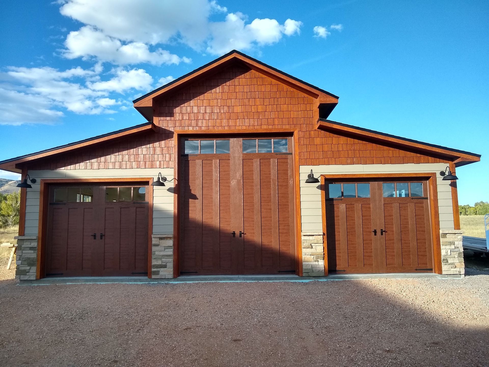 House with Three Wooden Garage Doors — Laramie, WY — Southeastern Wyoming Garage Doors