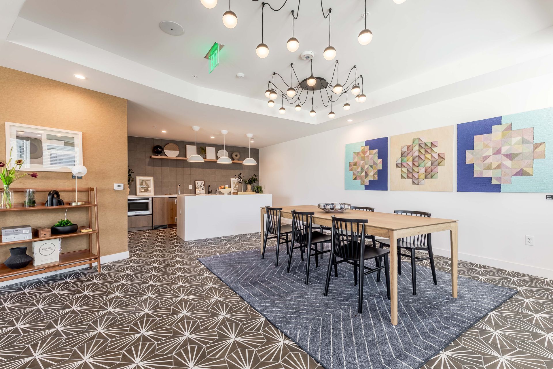 A dining room with a table and chairs and a rug.