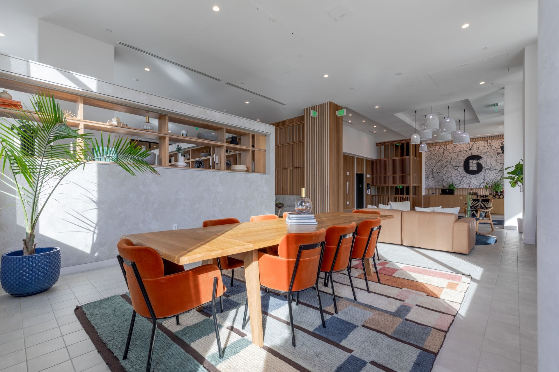 There is a table and chairs in the middle of the room.