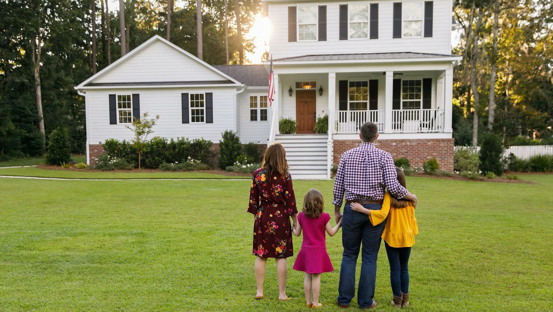 A family looking at there newly painted house