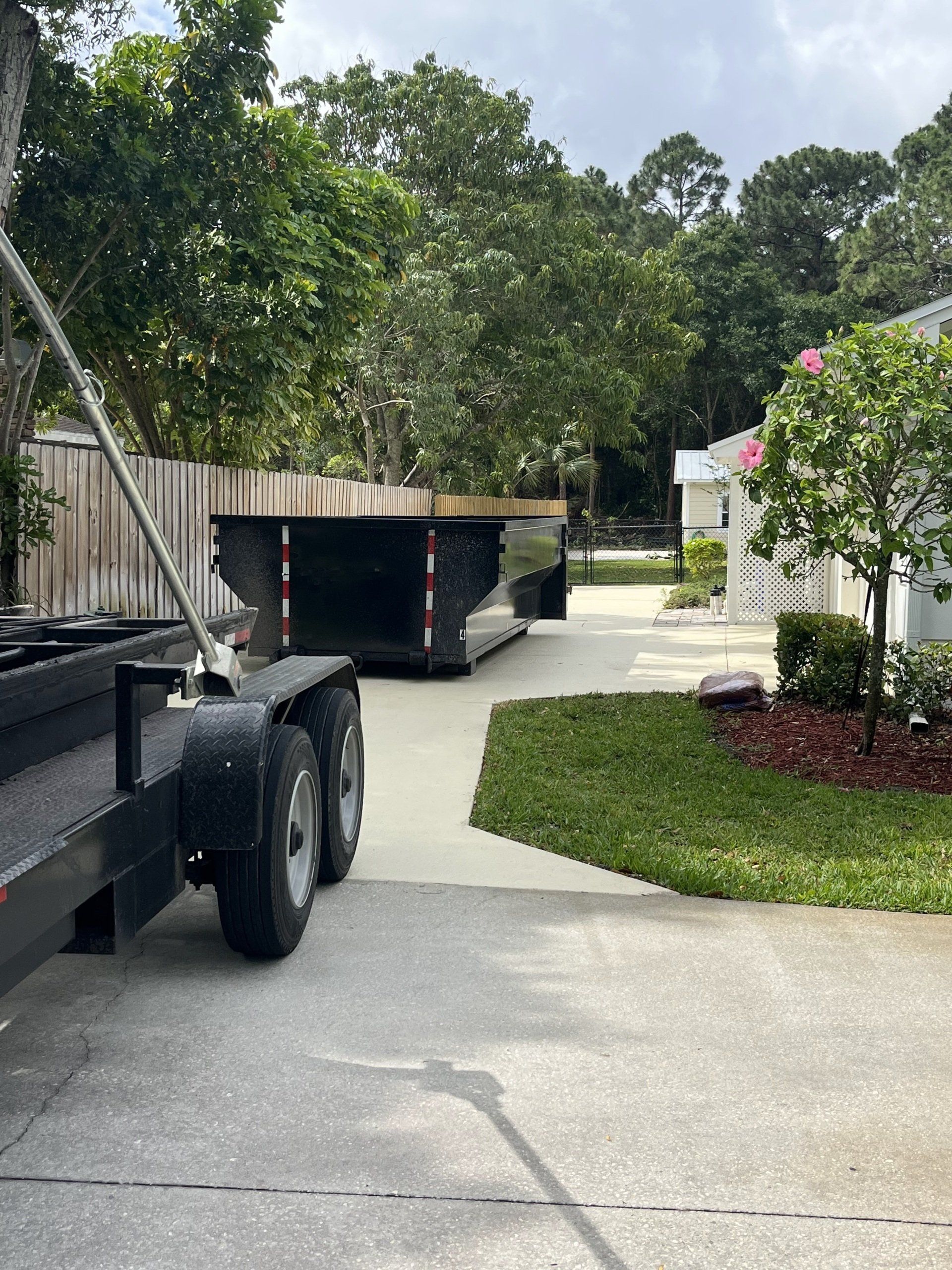 dumpster rental delivery into driveway of home