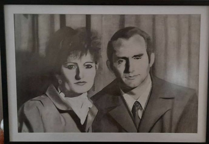 A man and a woman are posing for a black and white photo.