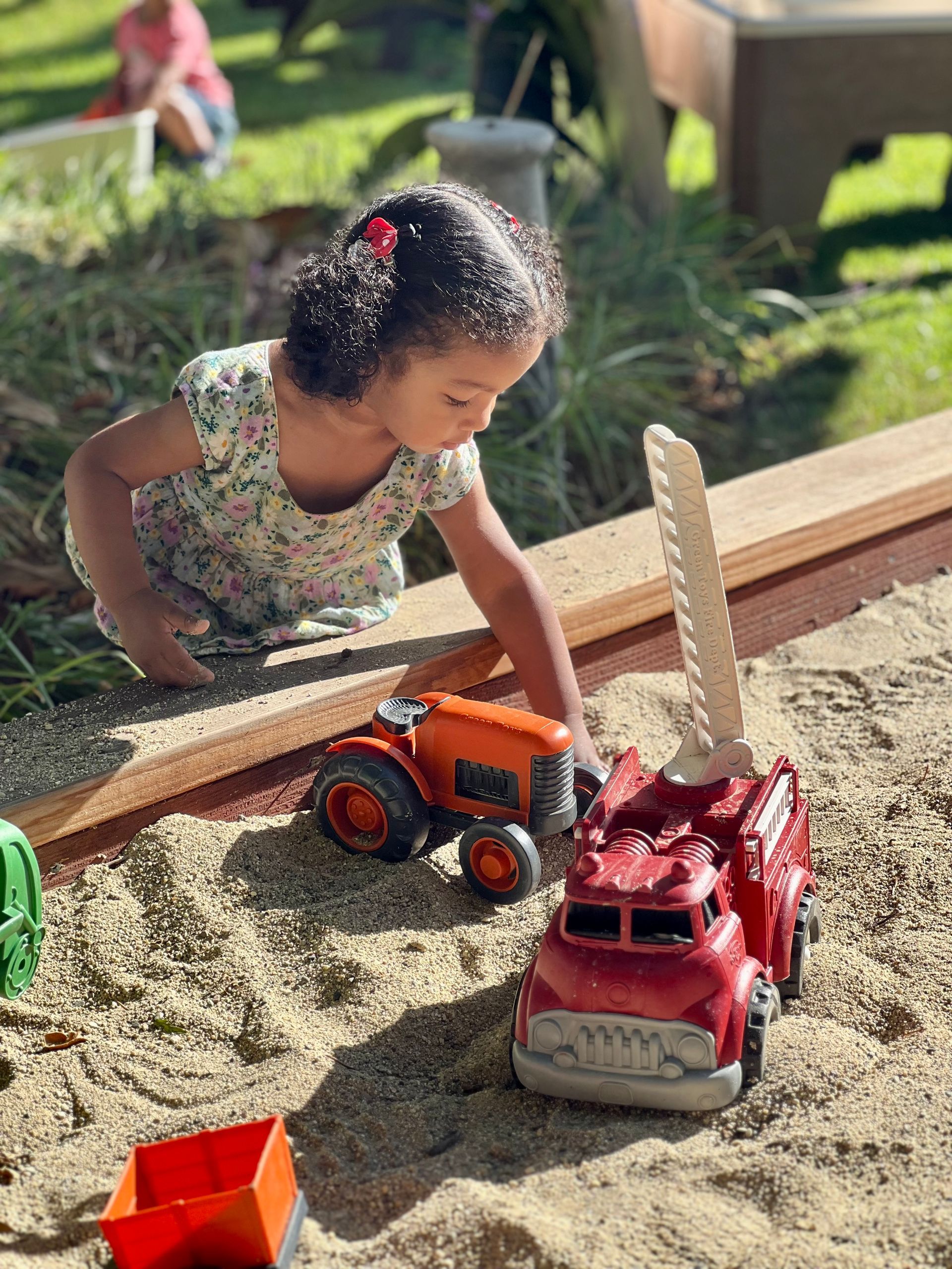 Montessori child playing at a sandbox.