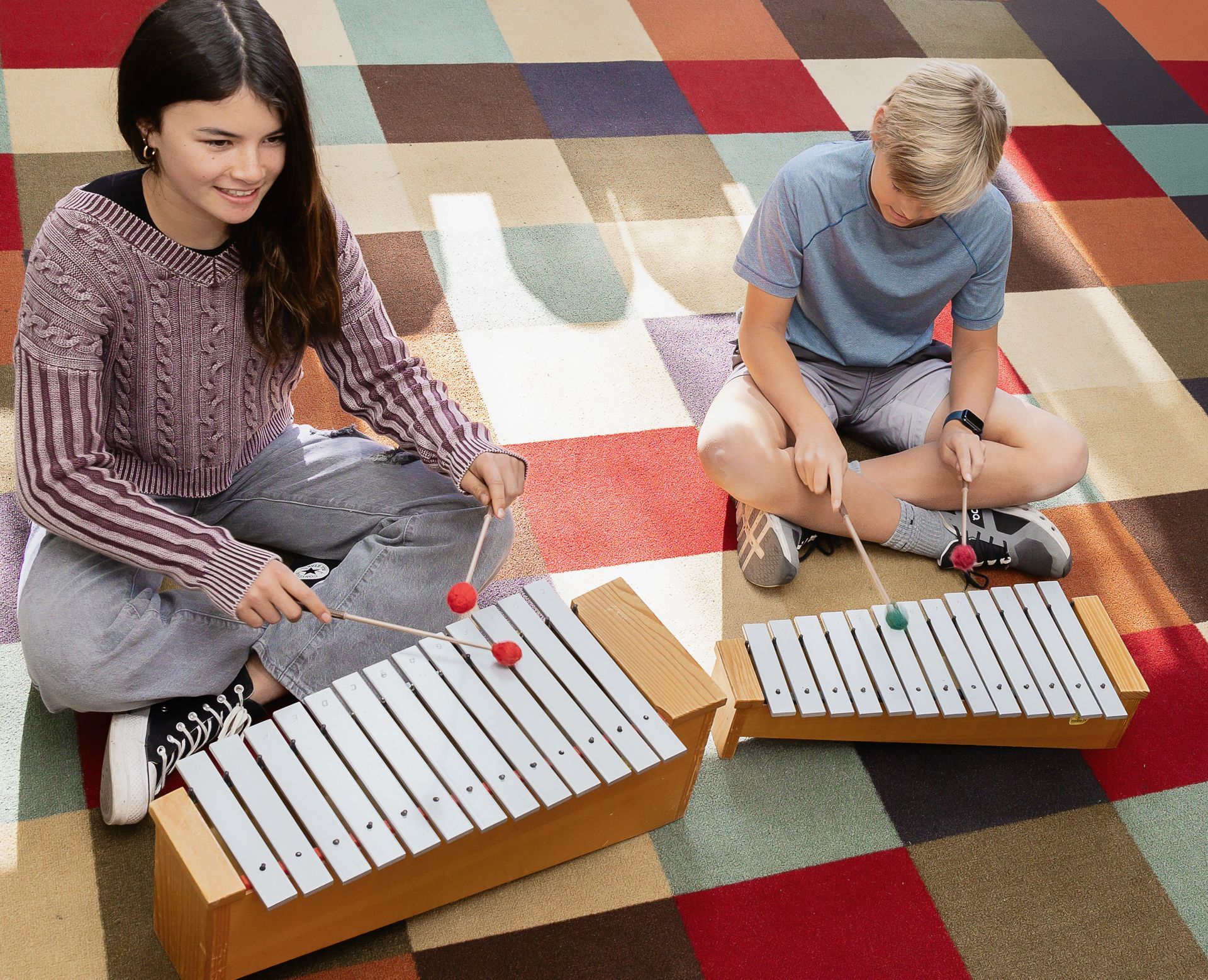 Montessori children playing the xylophone.