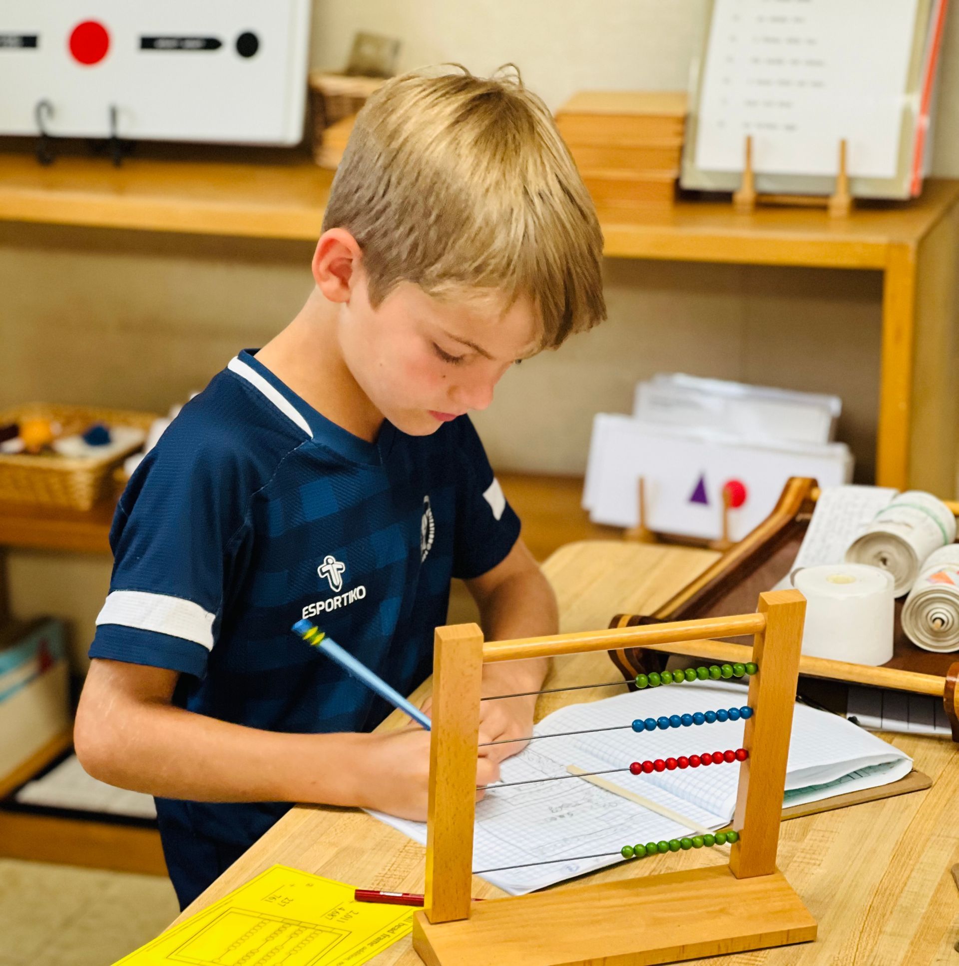 Montessori child working with math materials.