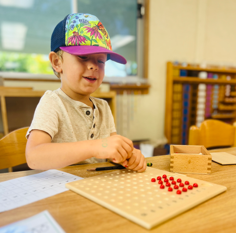 Child working with the Montessori multiplications board.