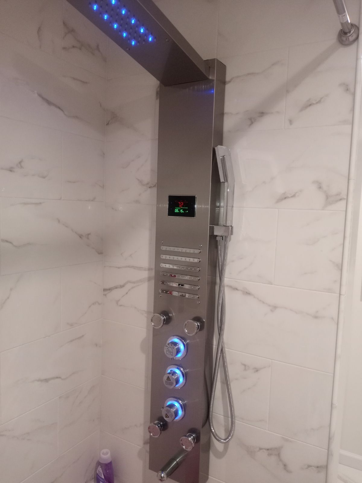 A stainless steel shower head with blue lights on it