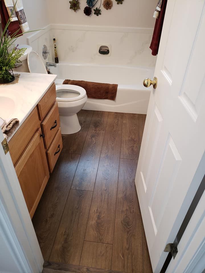 A bathroom with a toilet , sink , and bathtub.