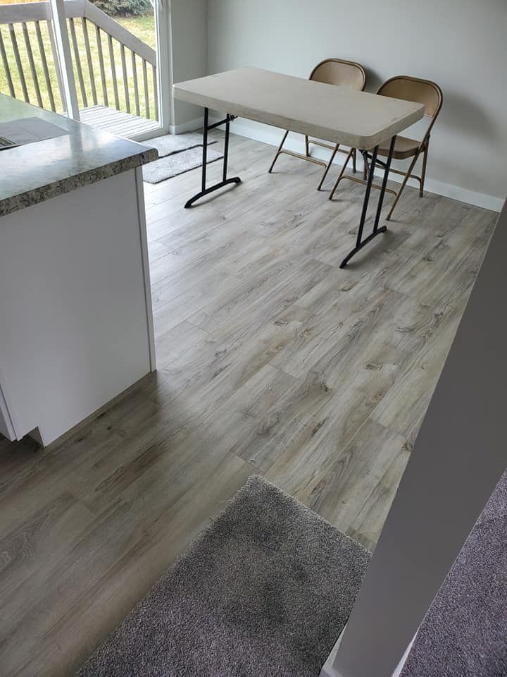 There is a table and chairs in the room.