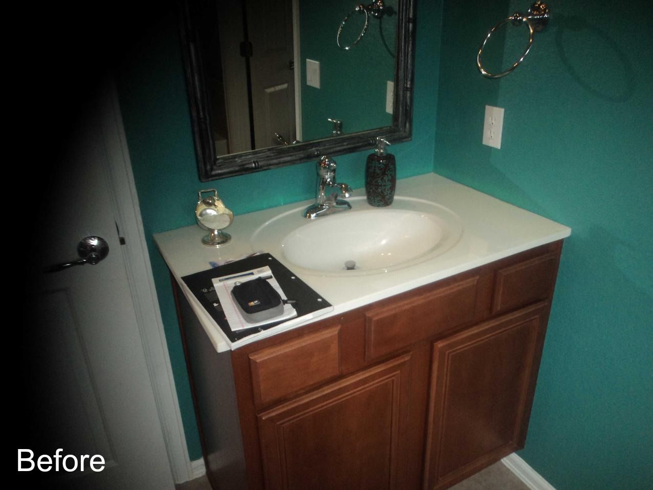 A before picture of a bathroom sink with a mirror