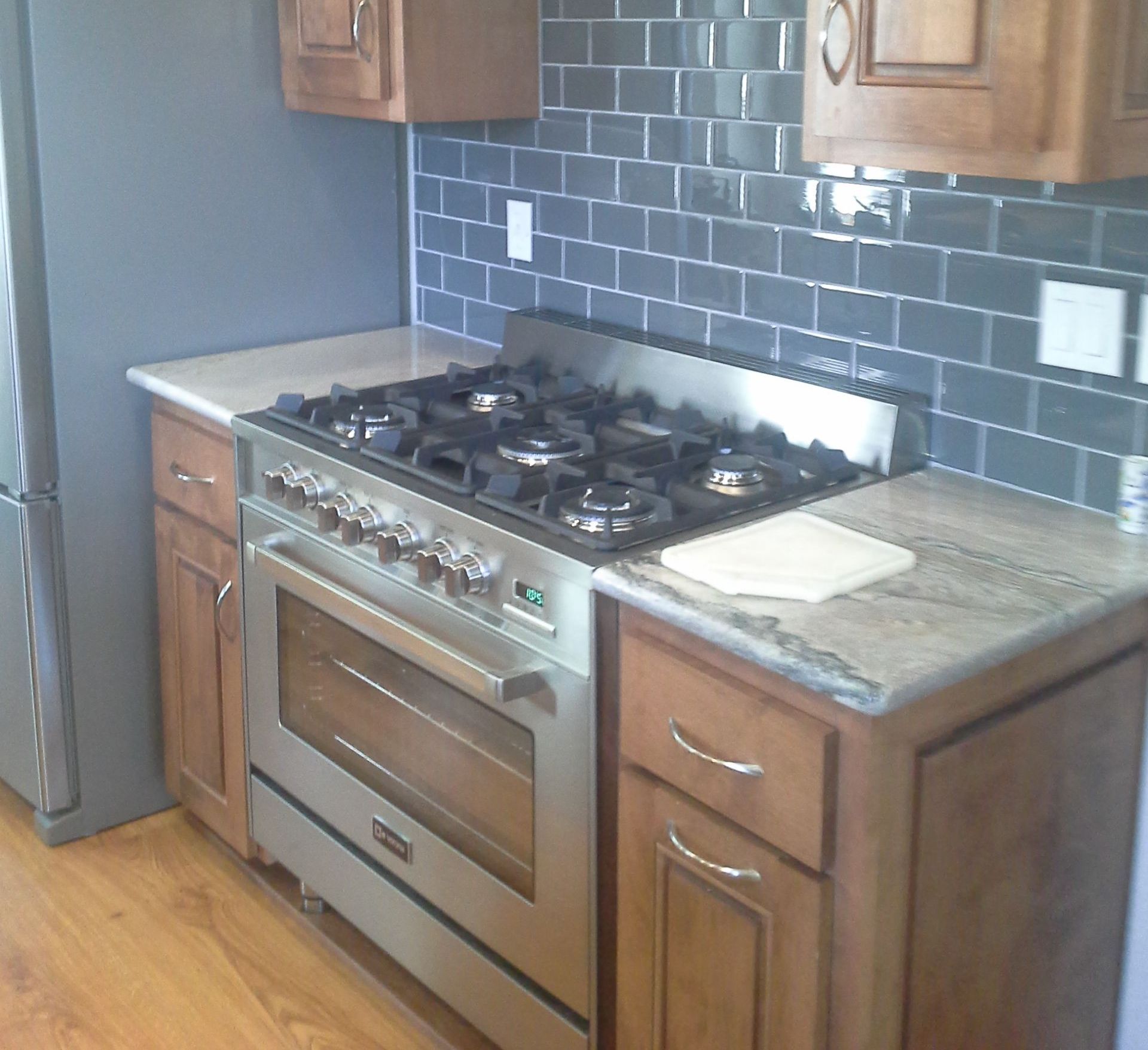 A kitchen with stainless steel appliances and wooden cabinets