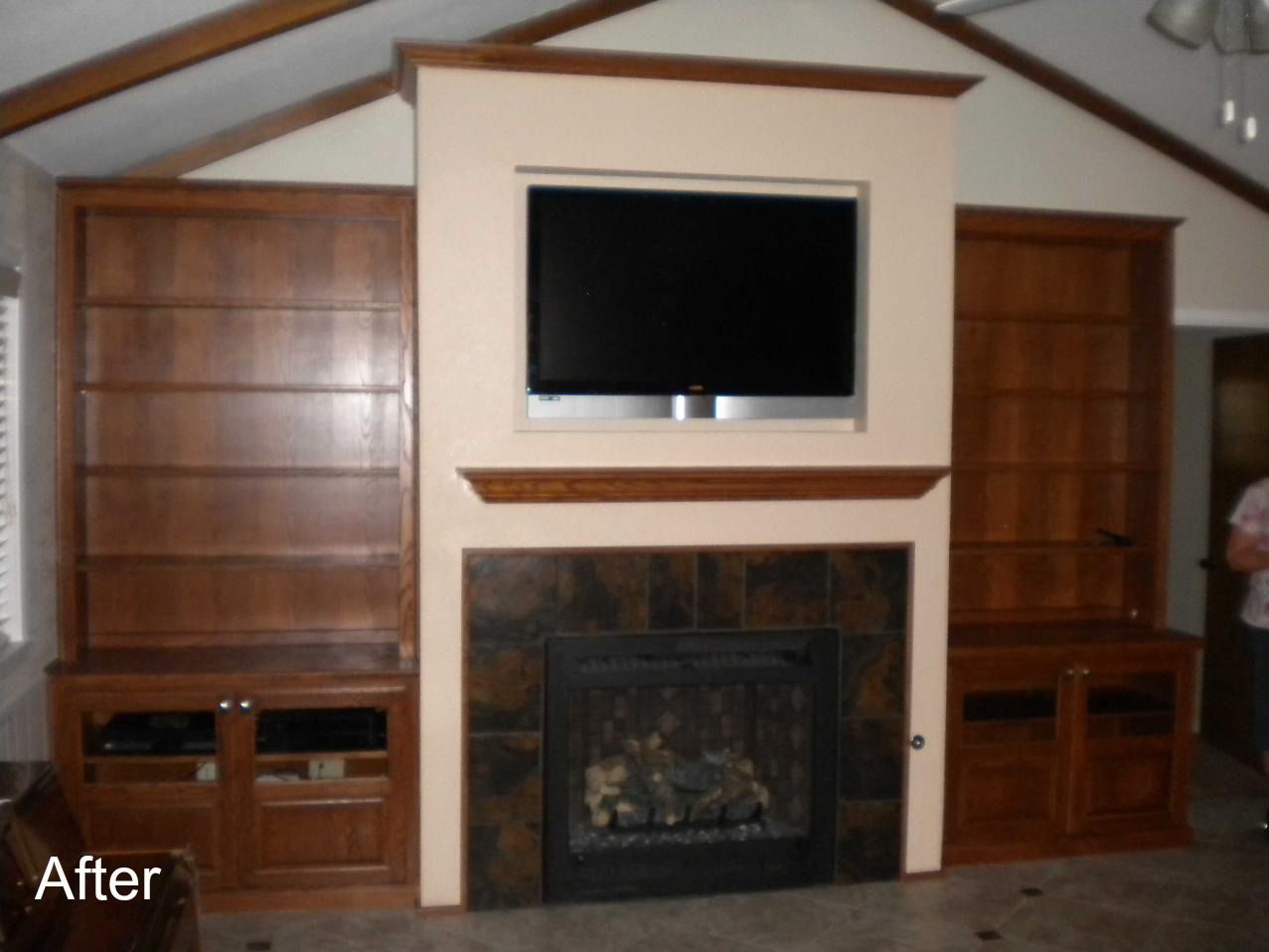 A living room with a fireplace and a flat screen tv above it