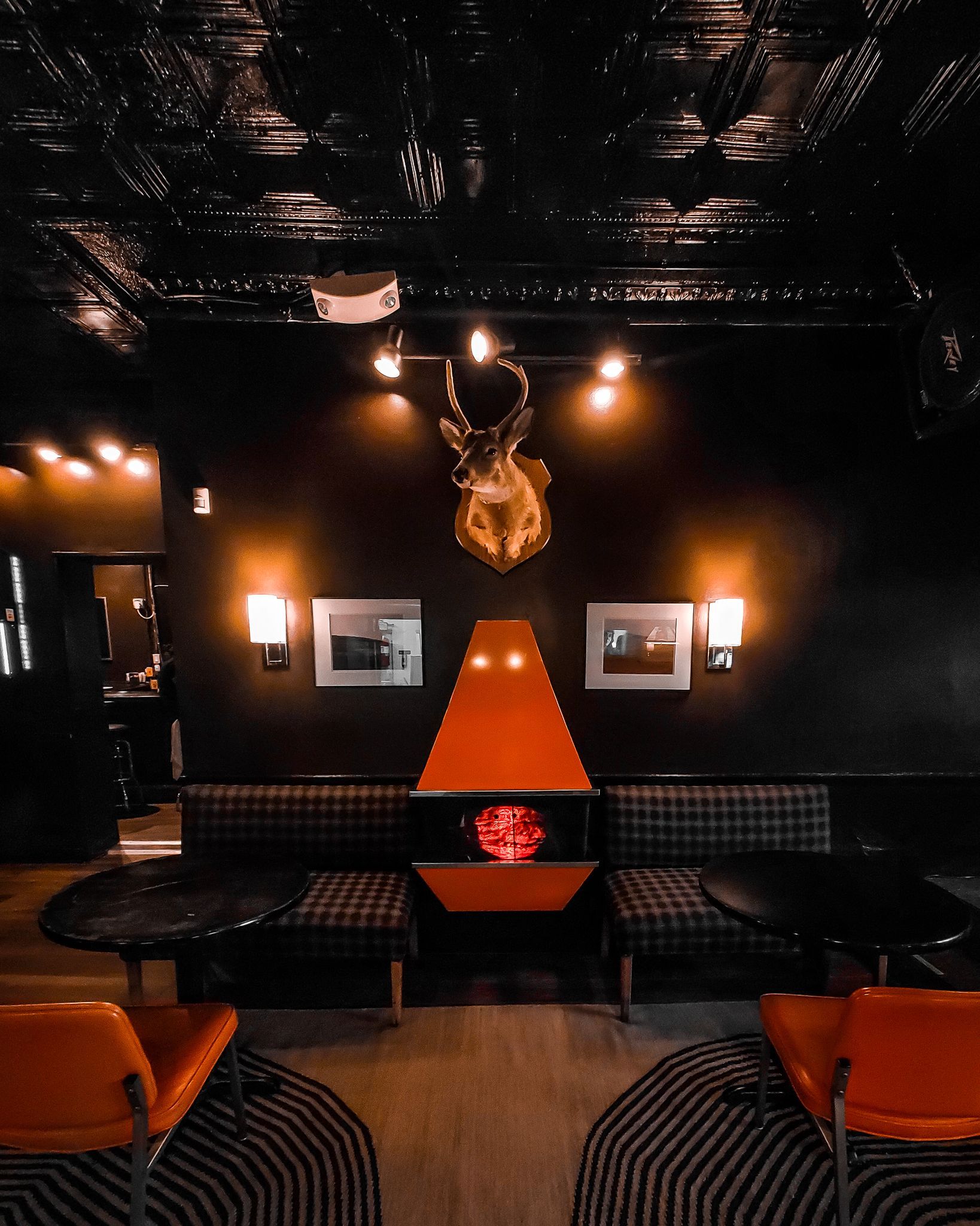 Cozy dining area at Bad Ending featuring a fireplace and deer head