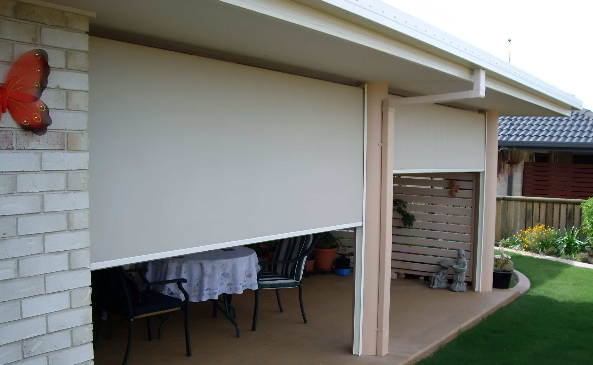A Patio With A Table And Chairs And A Butterfly On The Wall — Advantage Screens and Blinds Hervey Bay In Pialba, QLD