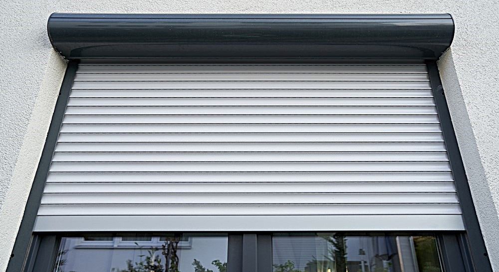 A Close Up Of A Window With A Roller Shutter On It — Advantage Screens and Blinds Hervey Bay In Pialba, QLD