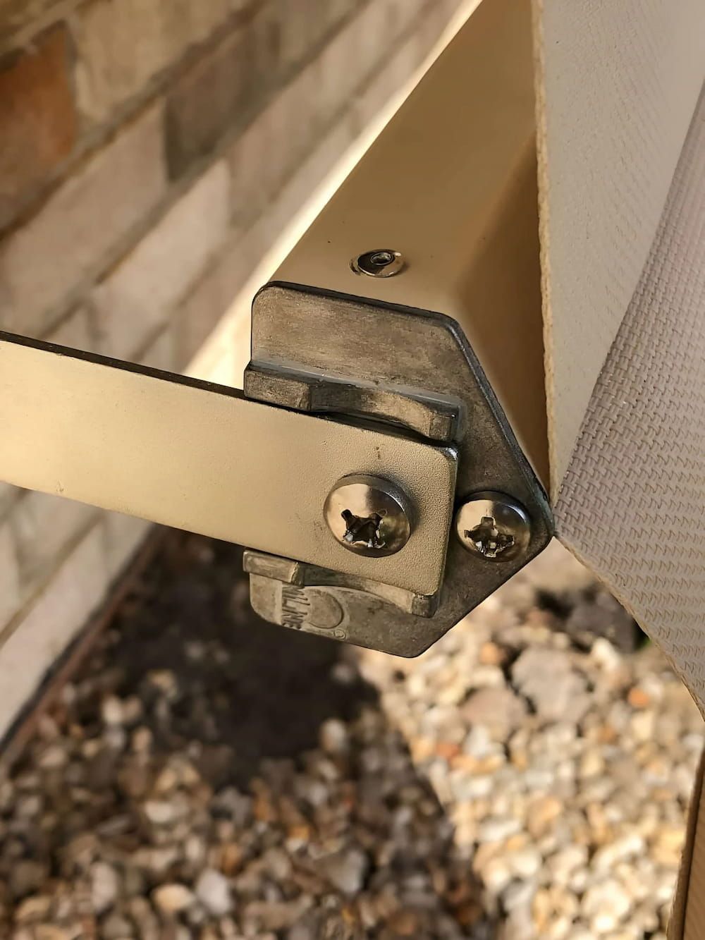 A Close Up Of A Metal Bracket With Screws On It — Advantage Screens and Blinds Hervey Bay In Pialba, QLD