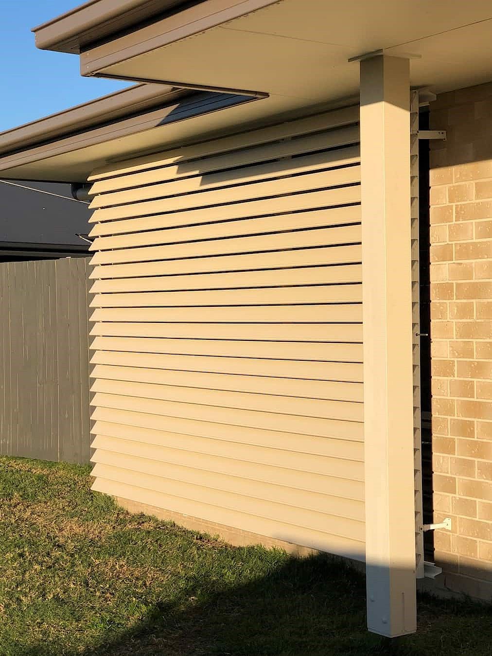 The Side Of A House With A Brick Wall And A Pillar — Advantage Screens and Blinds Hervey Bay In Pialba, QLD
