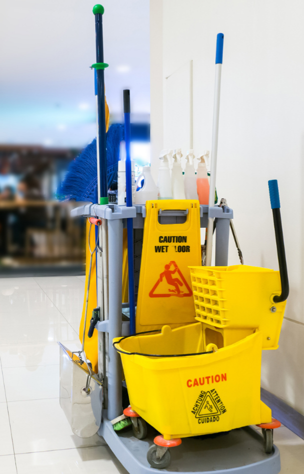 Cleaning supplies cart with mop, broom, caution sign, and buckets.