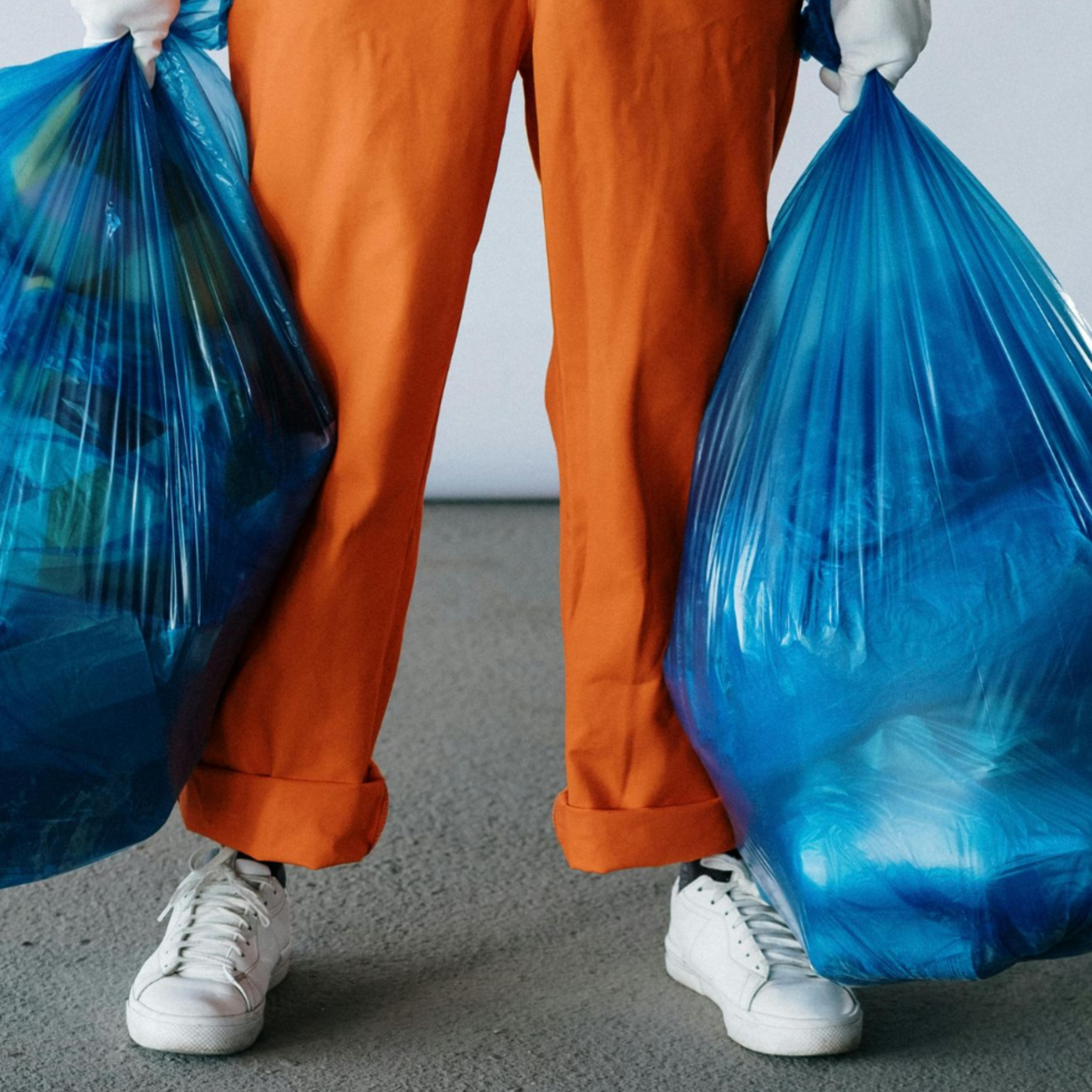 Blurred view of a shopping mall hallway with storefronts, warm lighting, and some figures walking.