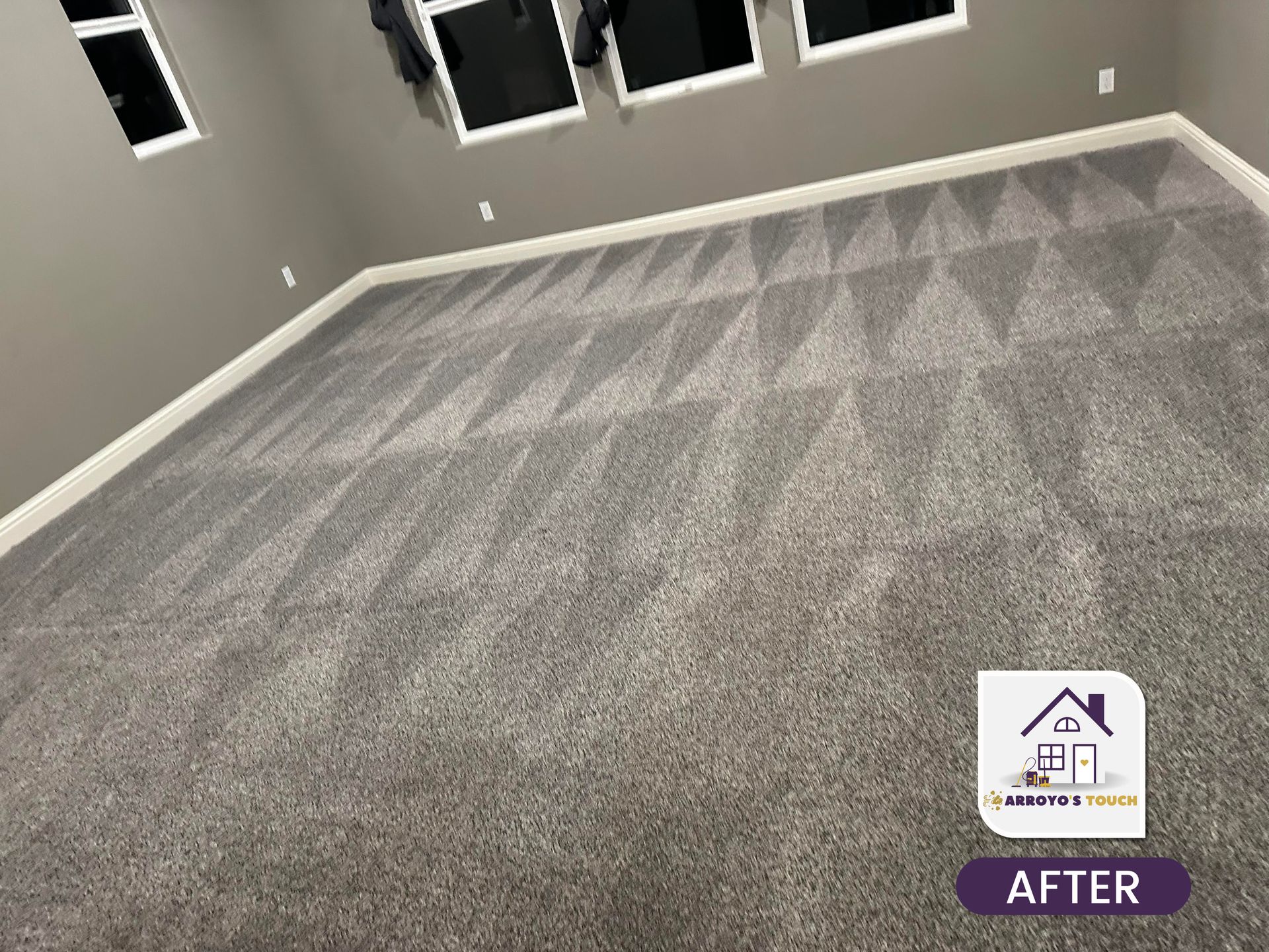 Cleaned gray carpet with triangular patterns in a room, after cleaning.