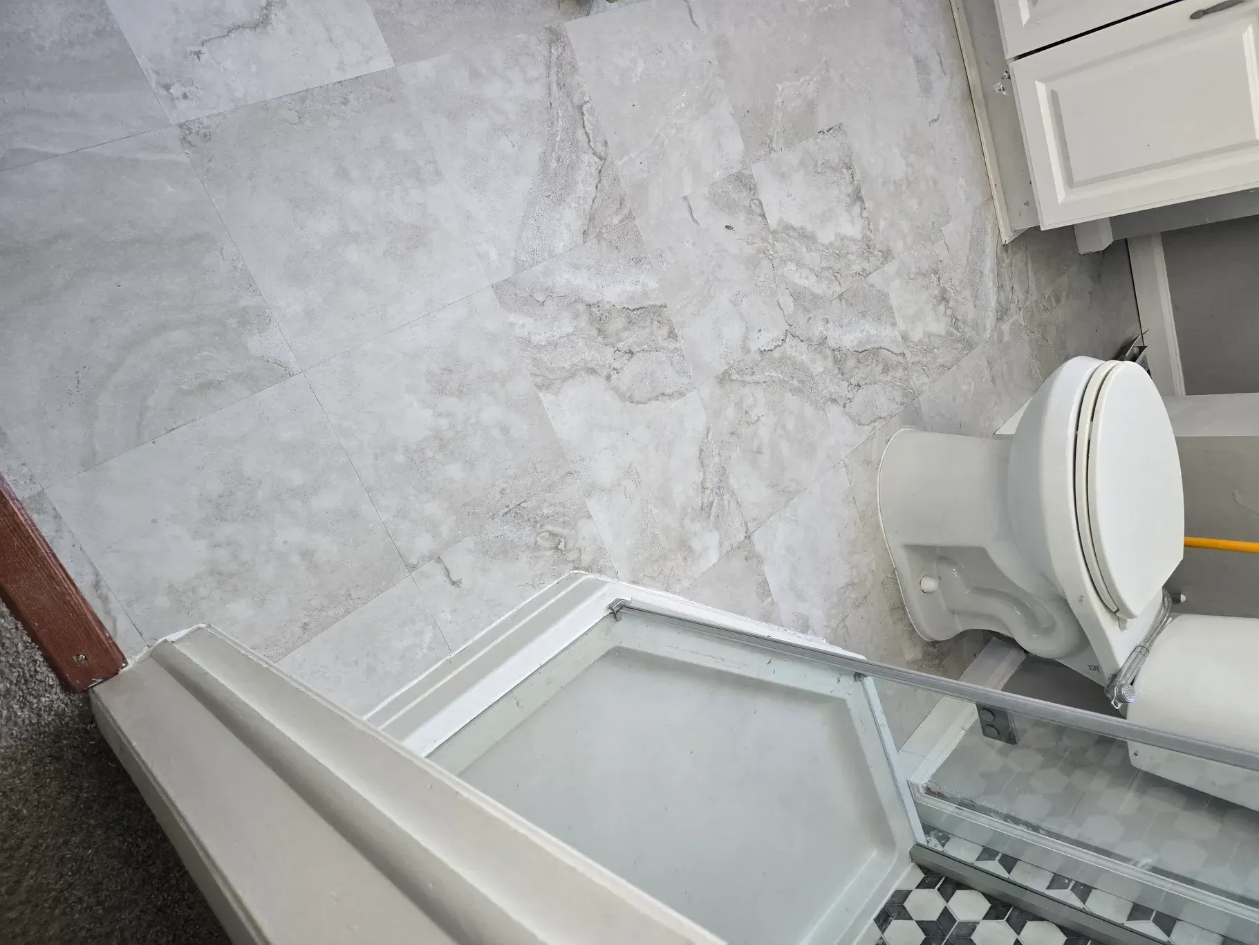 A bathroom with a toilet and a mirror