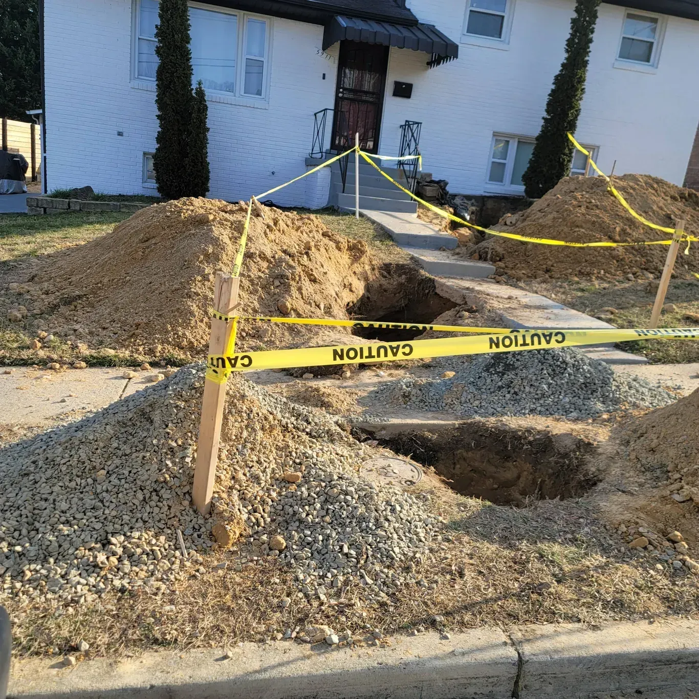 A pile of dirt is surrounded by caution tape