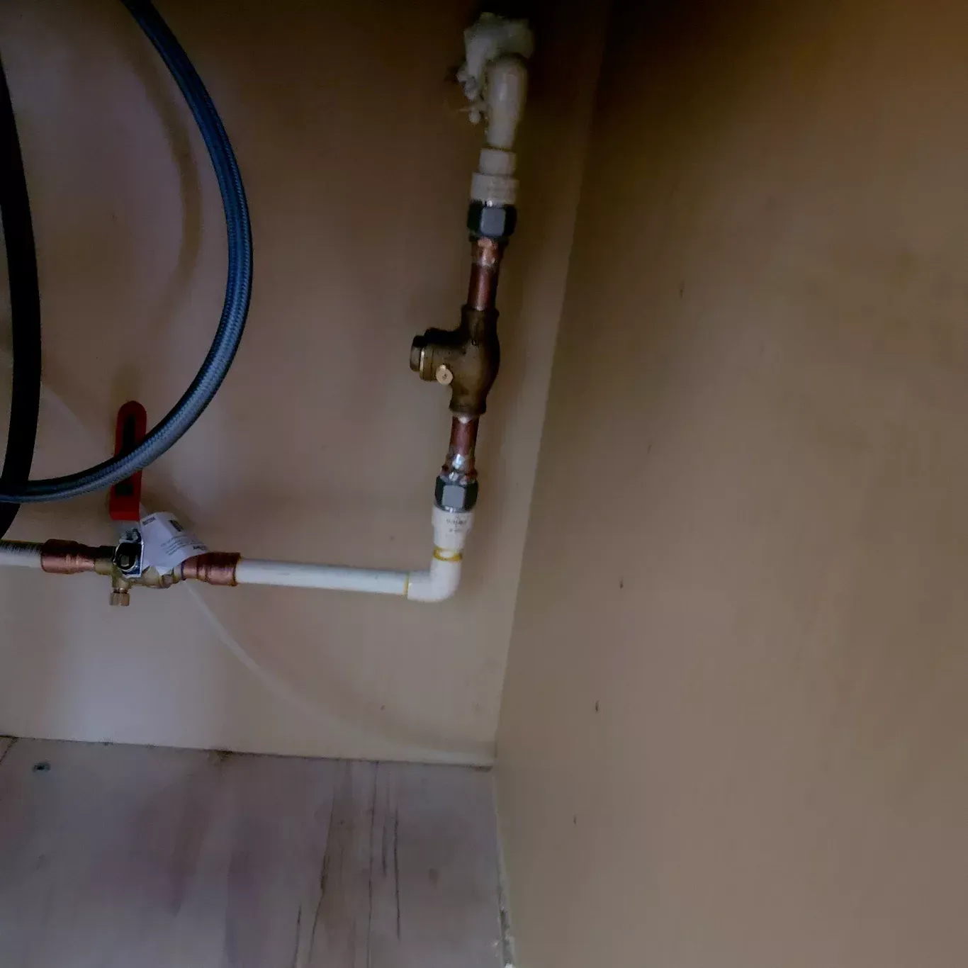 A close up of a water pipe in a cabinet