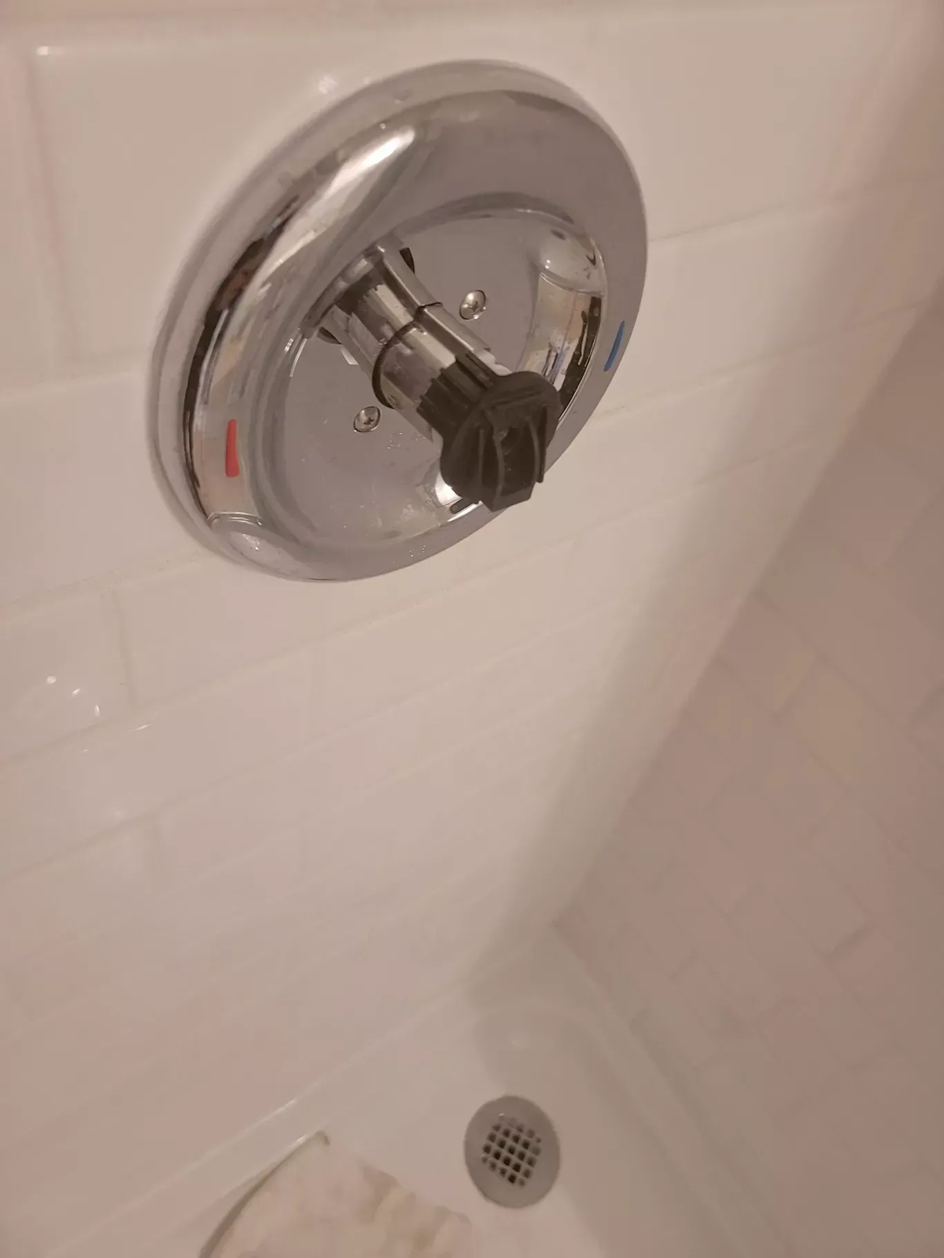 A close up of a shower head in a bathtub.