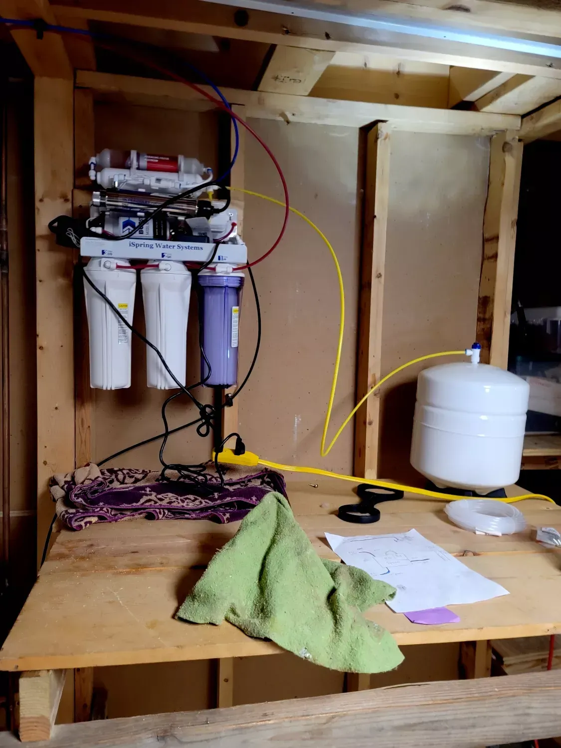 A wooden table with a water filter on it