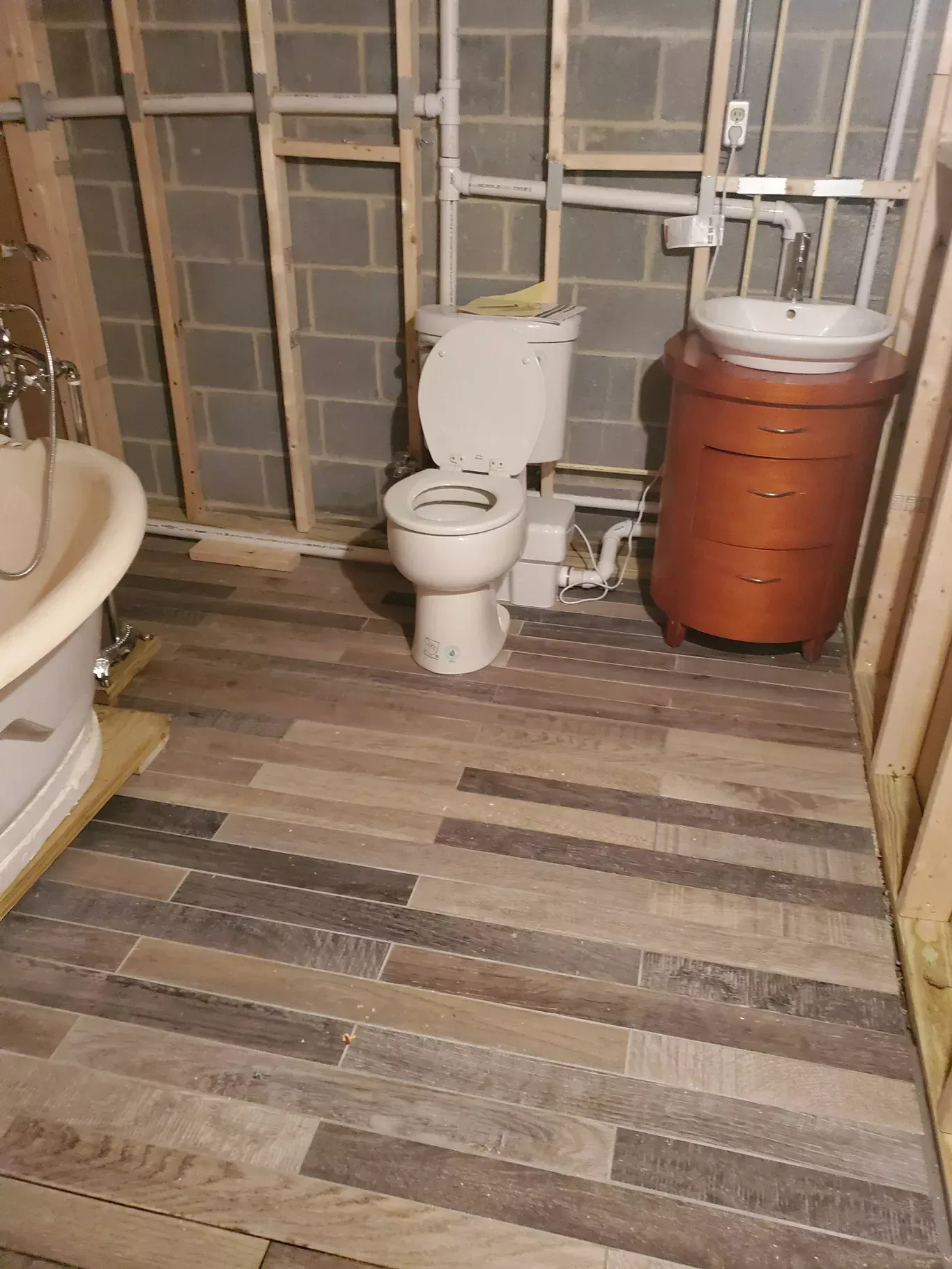 A bathroom with a toilet , sink , and bathtub.