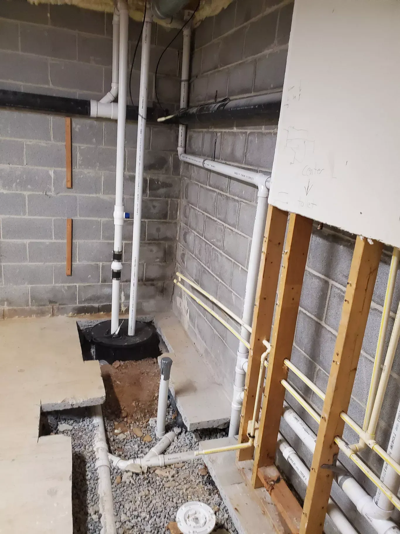 A basement with a lot of pipes coming out of it.