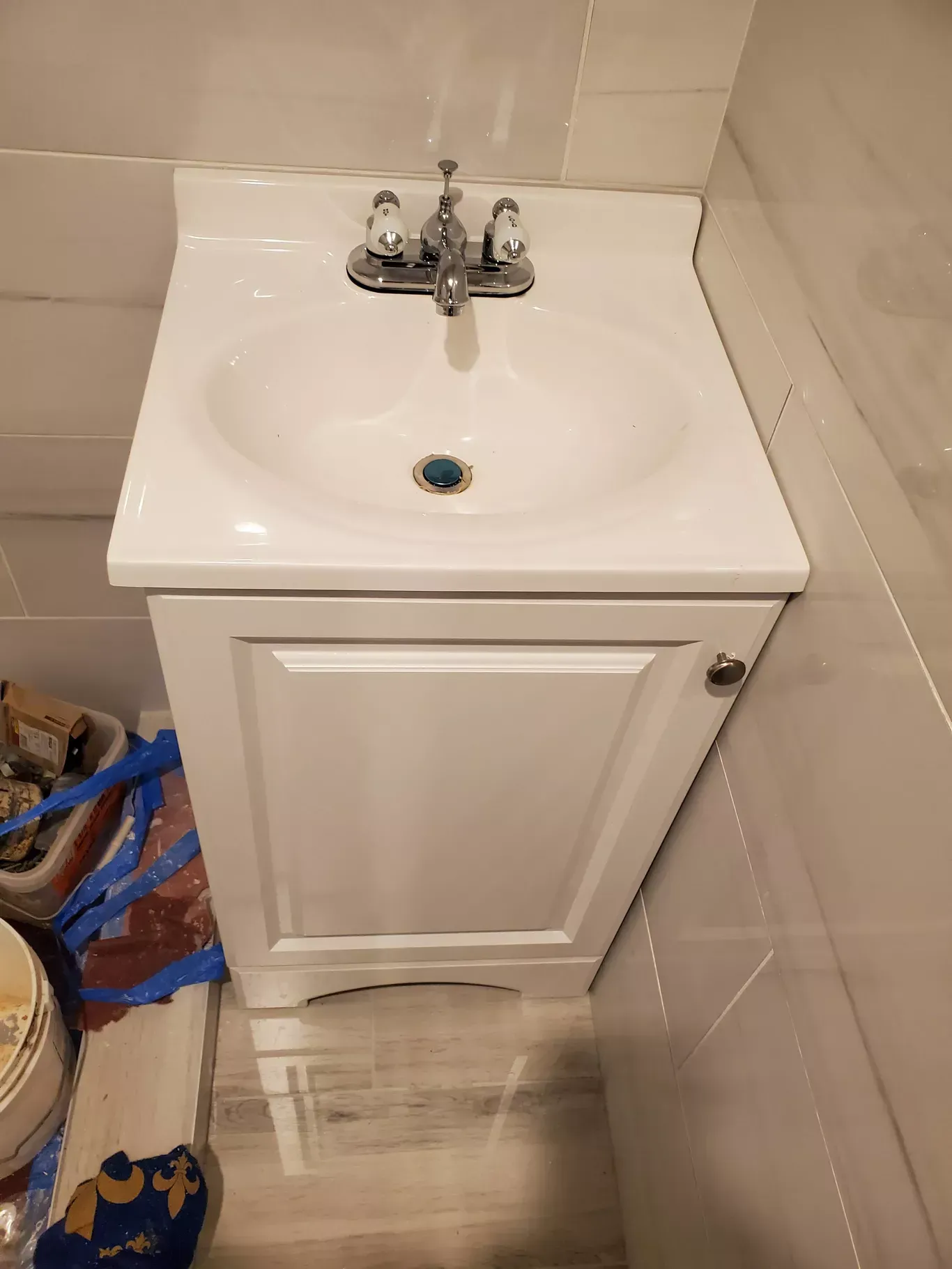 A bathroom sink with a cabinet underneath it and a faucet.