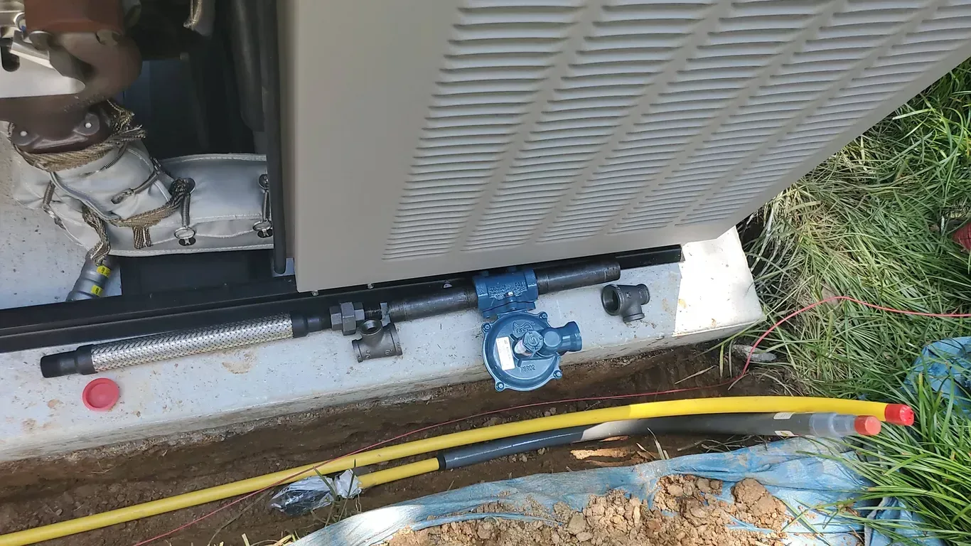 A hose is laying on the ground next to a machine.