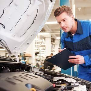 Man inspecting car machine - Walt's Auto Service Center, Taunton, MA