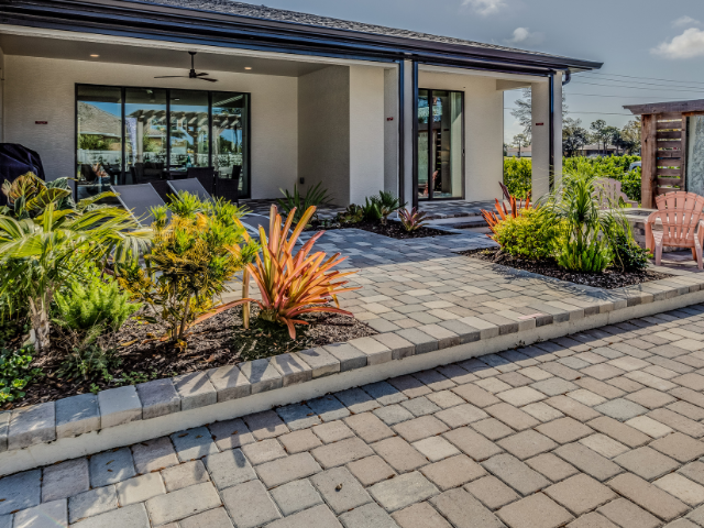 A house with a patio and chairs in front of it.