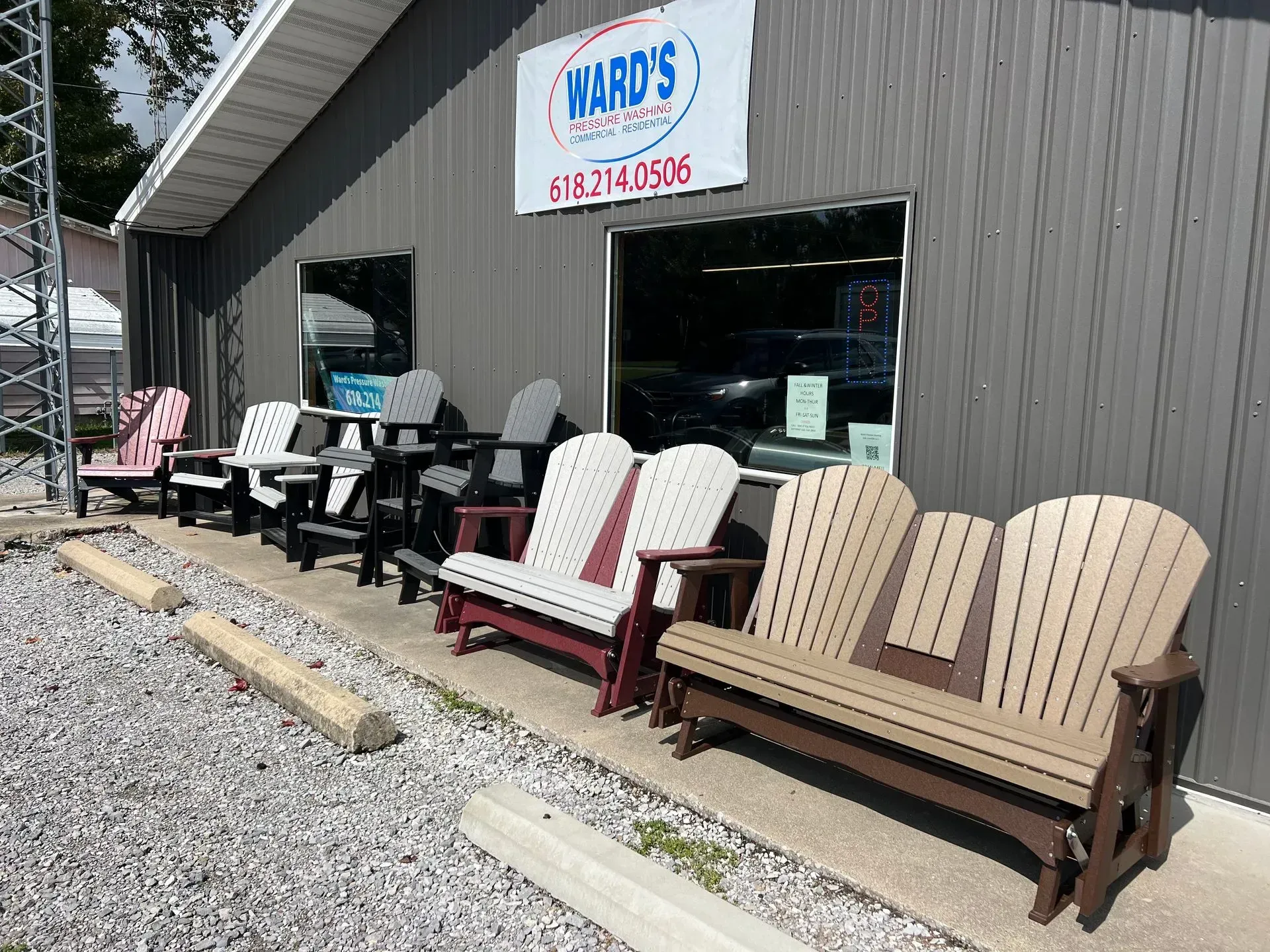 Ward's furniture store exterior with colorful Adirondack chairs and benches on display.