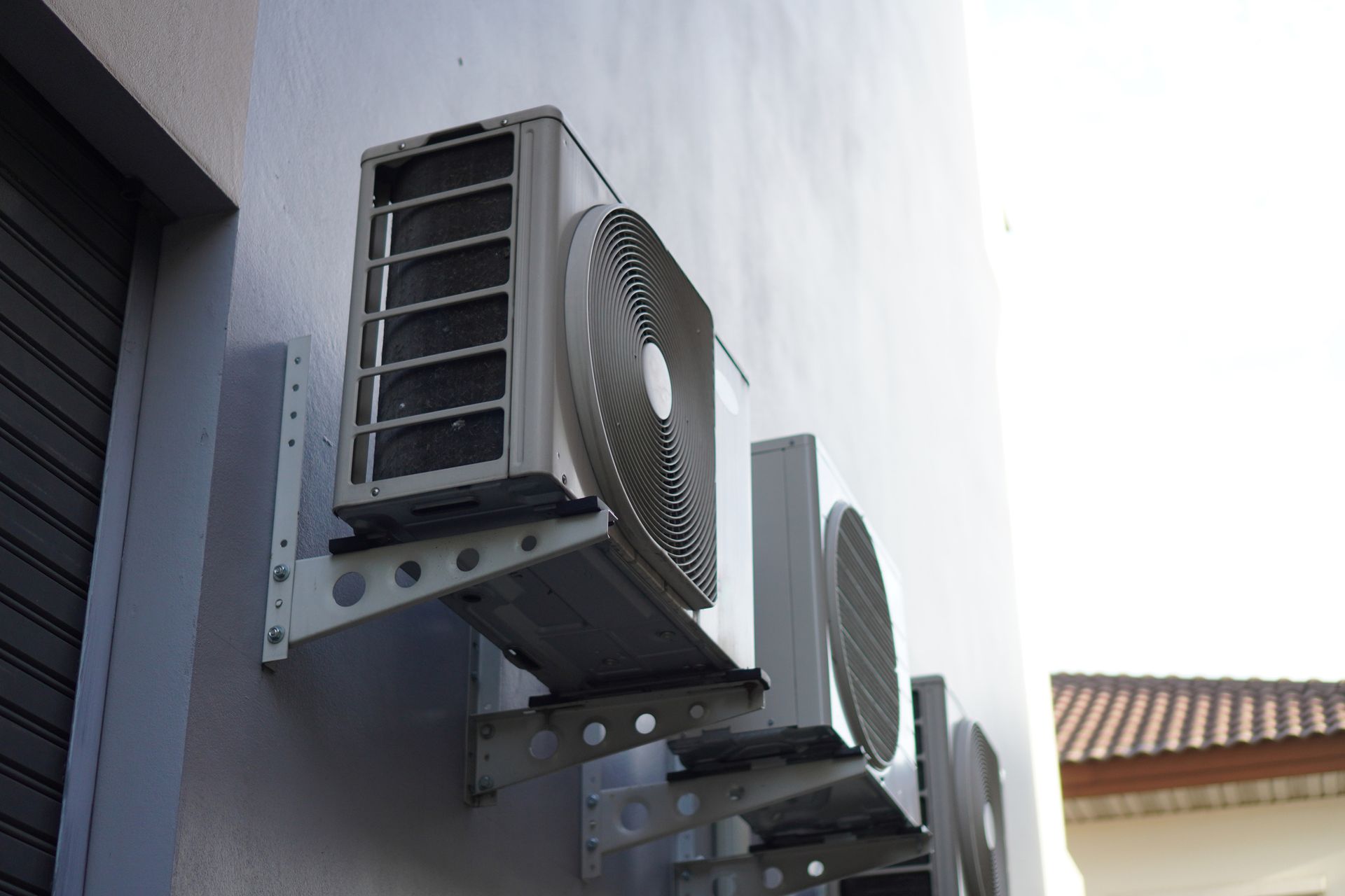 An air conditioner is mounted on the side of a building.