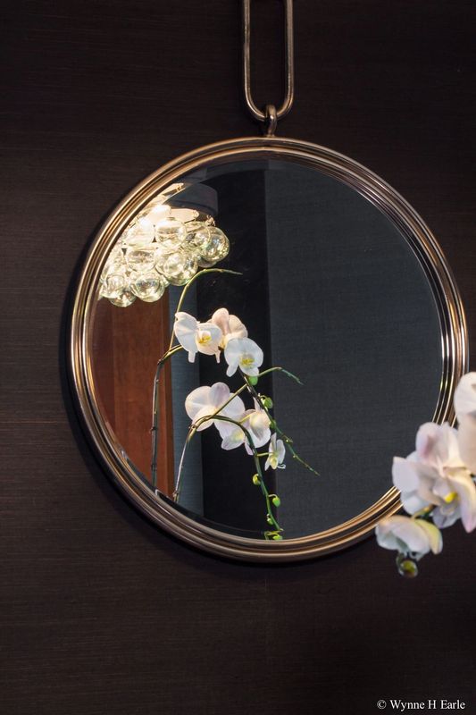 A Mirror And Orchid Flowers — Seattle, WA — Blend Interior Design Studio