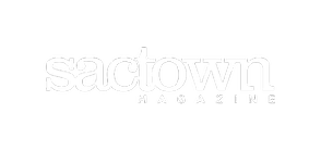 A white logo for sactown magazine on a white background.