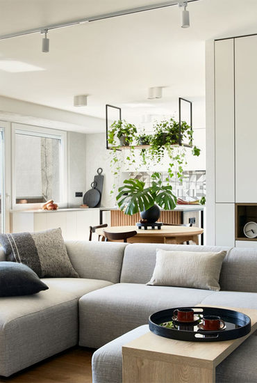 A living room with a sectional couch and a coffee table