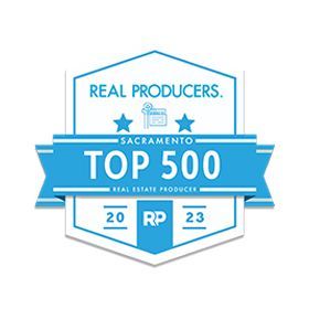 A badge that says real producers sacramento top 500 real estate producers