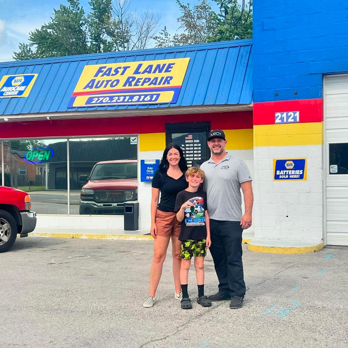 Family in Front of Fast Lane Auto Repair on Triplett Street - Owensboro Auto Repair