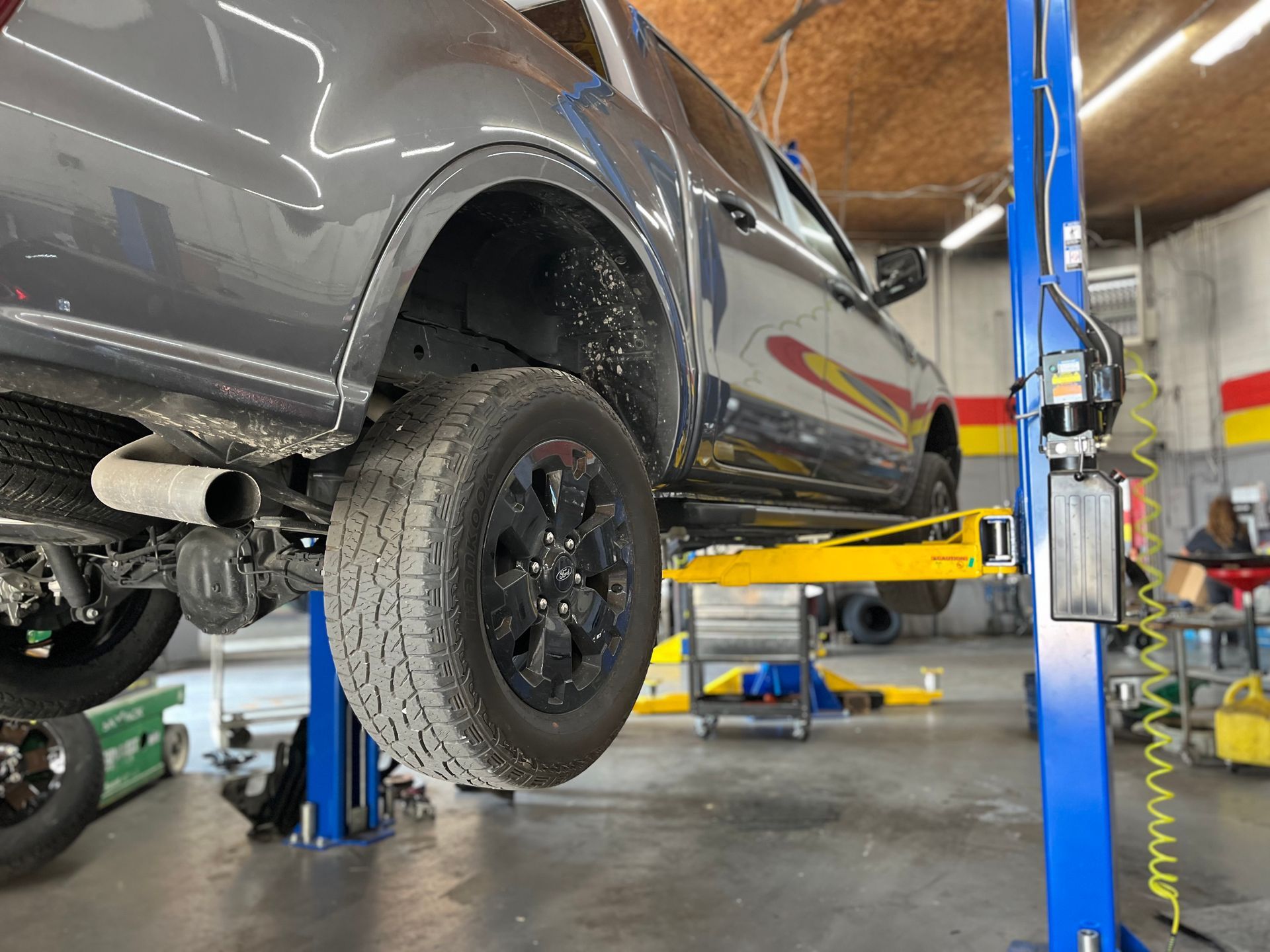 A Truck is Sitting on a Lift in Fast Lane Auto Repair - Owensboro Auto Repair