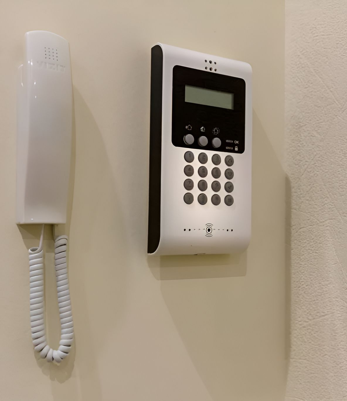 A Telephone And A Security System Are On A Wall — Country to Coast Cabling in Kawana, QLD
