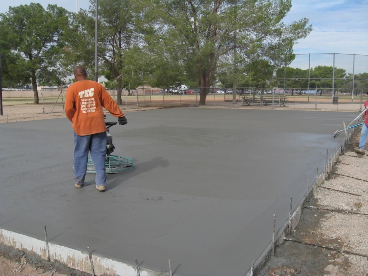 A man wearing an orange shirt that says fsc on it