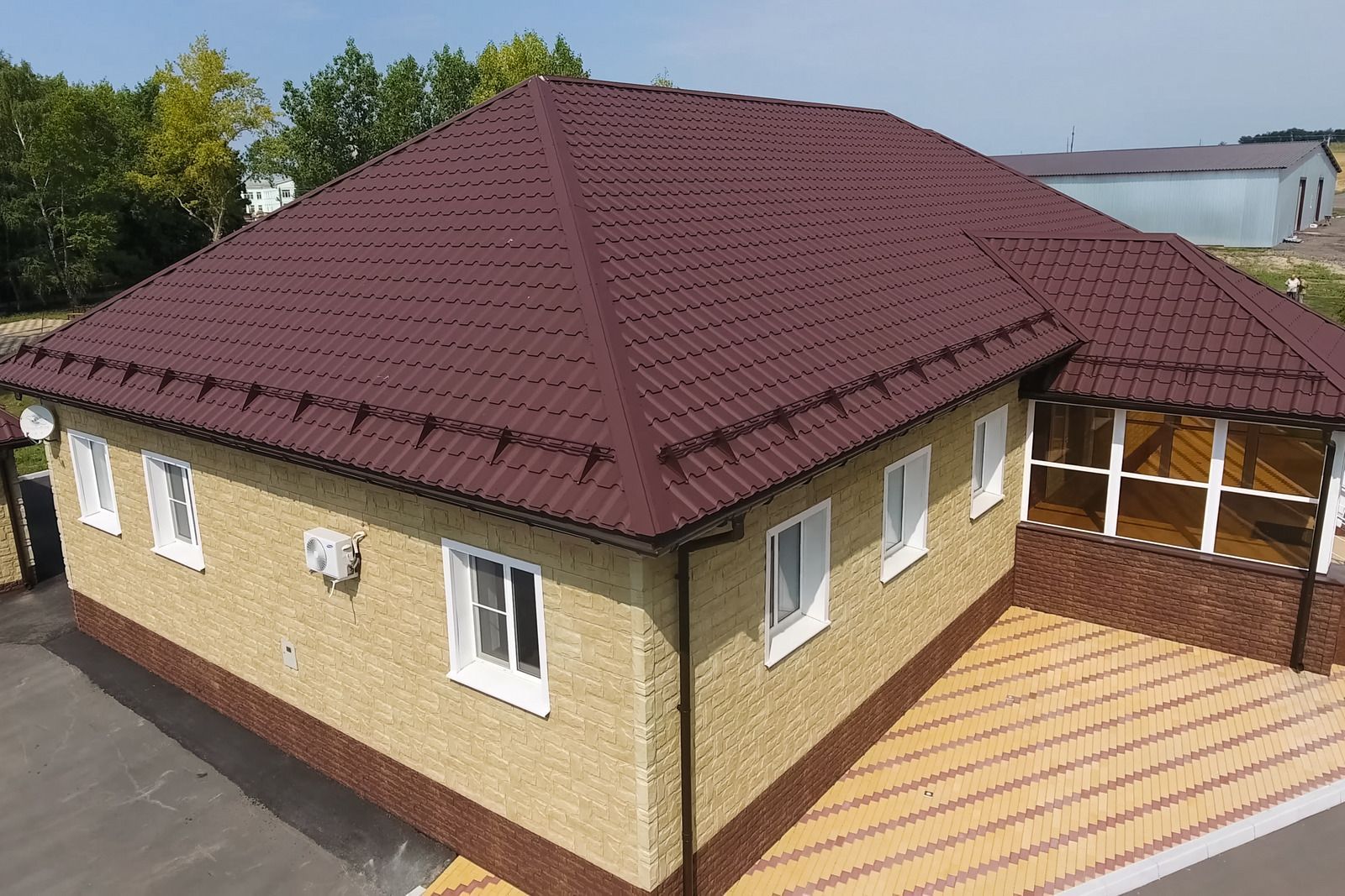 An aerial view of a house with a brown roof.