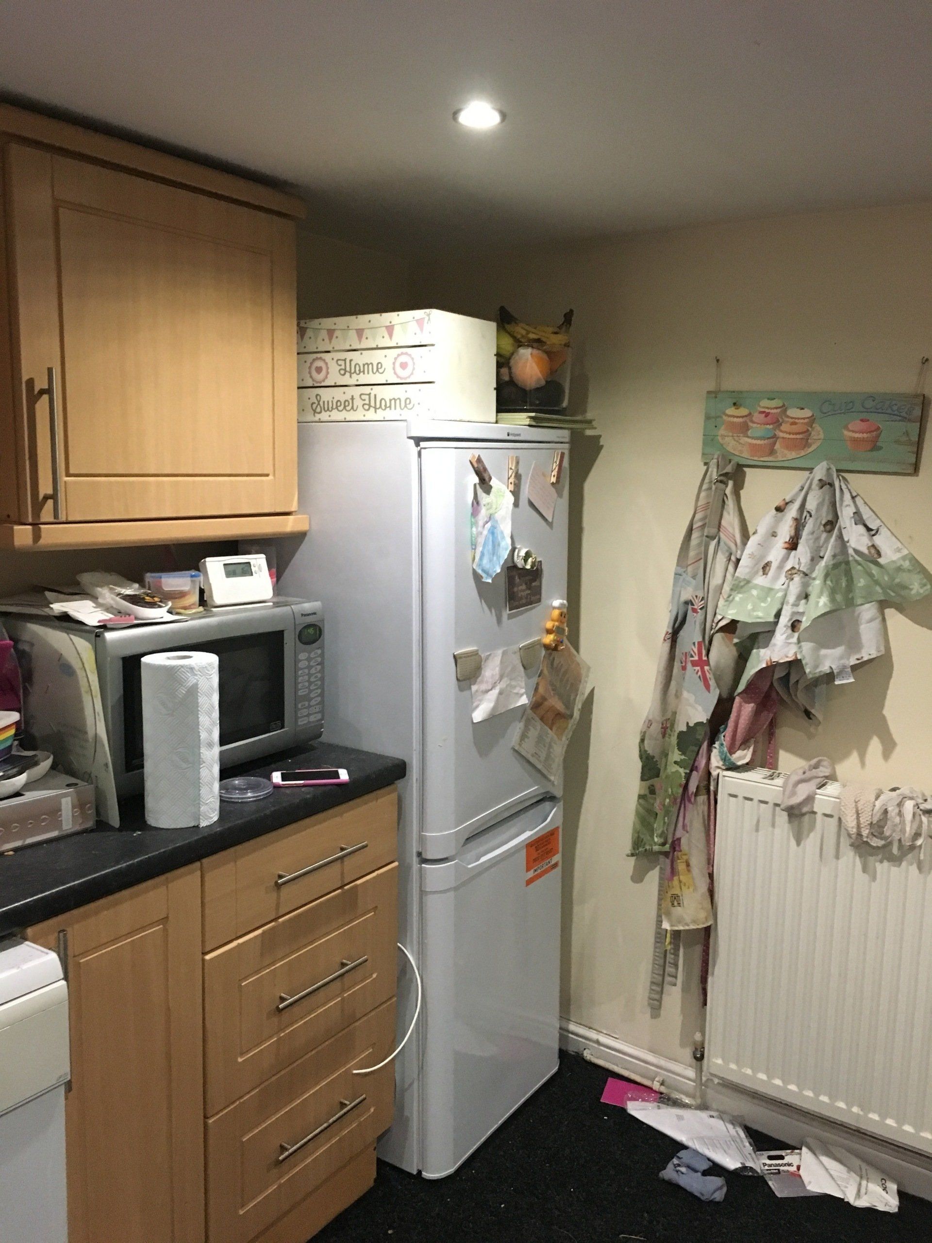 Clutter on microwave and on top of fridge